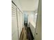 Hallway leading to a bathroom and closet with a double vanity and gold fixtures at 4100 Player Cir # 101, Orlando, FL 32808