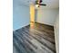 Spacious bedroom with modern floors, ceiling fan, and access to another room at 4100 Player Cir # 101, Orlando, FL 32808