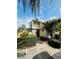 Charming home featuring a pergola over the entrance, lush landscaping, and a well-maintained walkway at 4100 Player Cir # 101, Orlando, FL 32808