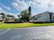 Well-maintained community with lush green spaces, mature trees, and a glimpse of the pool area at 4100 Player Cir # 101, Orlando, FL 32808