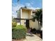 Charming two-story home with modern architecture, a cozy pergola entryway, and mature landscaping at 4100 Player Cir # 101, Orlando, FL 32808