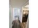 Hallway featuring modern floors, stainless steel refrigerator, and access to multiple rooms at 4100 Player Cir # 101, Orlando, FL 32808