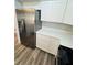 Bright kitchen featuring stainless steel refrigerator, white cabinets, and modern countertops at 4100 Player Cir # 101, Orlando, FL 32808