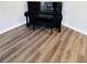 Close-up of the living room's modern floors and upright piano with bench seating at 4100 Player Cir # 101, Orlando, FL 32808