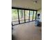 View of the screened porch with an elliptical machine and view to community pool at 4100 Player Cir # 101, Orlando, FL 32808