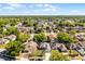 An aerial view of a beautiful neighborhood featuring lush trees and a picturesque lake creates a serene and inviting atmosphere at 4321 Iveyglen Ave, Orlando, FL 32826