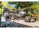 Outdoor patio area with a grill, shaded seating, and a well-maintained landscape at 4321 Iveyglen Ave, Orlando, FL 32826