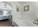 Bathroom with a luxurious bathtub, hardwood floors, and a view of the bedroom at 4321 Iveyglen Ave, Orlando, FL 32826