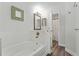 White bathroom with a bathtub and shower combination and updated fixtures at 4321 Iveyglen Ave, Orlando, FL 32826
