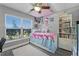 Bright bedroom with large window, ceiling fan, and bookshelf at 4321 Iveyglen Ave, Orlando, FL 32826