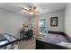 Bedroom with a desk, ceiling fan, and a window bringing in natural light at 4321 Iveyglen Ave, Orlando, FL 32826
