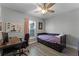 Bedroom featuring a desk, ceiling fan, and a window bringing in natural light at 4321 Iveyglen Ave, Orlando, FL 32826
