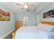 Comfortable bedroom with a ceiling fan, hardwood floors, and neutral paint, creating a relaxing atmosphere at 4321 Iveyglen Ave, Orlando, FL 32826