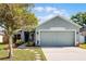 Charming single-story home with a well-manicured lawn, mature trees, and a two-car garage at 4321 Iveyglen Ave, Orlando, FL 32826