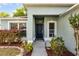 Inviting entryway featuring a dark door with sidelights and decorative landscaping at 4321 Iveyglen Ave, Orlando, FL 32826