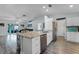 Open concept kitchen with a granite countertop island and view of the living area at 4321 Iveyglen Ave, Orlando, FL 32826