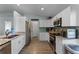 Modern kitchen featuring stainless steel appliances, white cabinets, and granite countertops at 4321 Iveyglen Ave, Orlando, FL 32826