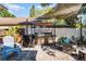 Beautiful outdoor kitchen with stone accents, a built-in grill, and a comfortable seating area at 4321 Iveyglen Ave, Orlando, FL 32826