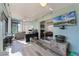 Bright sunroom with hardwood floors, desk, and sliding glass doors to the backyard, perfect for a home office and entertaining at 4321 Iveyglen Ave, Orlando, FL 32826