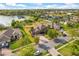 Beautiful aerial view of a community home with a serene lake and palm trees at 4822 Lake Milly Dr, Orlando, FL 32839