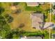 A top-down view reveals the home, expansive yard, mature trees, and inviting outdoor seating at 4822 Lake Milly Dr, Orlando, FL 32839