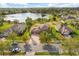 Picturesque aerial view of a home's manicured lawn and serene lake, capturing the essence of the property at 4822 Lake Milly Dr, Orlando, FL 32839