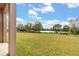 Expansive backyard with lush green grass and serene views of a tranquil lake, offering ultimate privacy at 4822 Lake Milly Dr, Orlando, FL 32839
