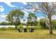 Beautiful backyard with seating around a peaceful lake with surrounding trees, creating a relaxing atmosphere at 4822 Lake Milly Dr, Orlando, FL 32839