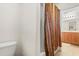 Bathroom featuring wood cabinets, a framed mirror, and a decorative shower curtain at 4822 Lake Milly Dr, Orlando, FL 32839