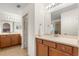 Bathroom featuring a double sink vanity, a large mirror, and tile floors at 4822 Lake Milly Dr, Orlando, FL 32839