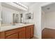 Well-lit bathroom featuring double sinks with wood cabinets and neutral countertops at 4822 Lake Milly Dr, Orlando, FL 32839