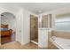 Bathroom with a glass enclosed shower, soaking tub and tile floors at 4822 Lake Milly Dr, Orlando, FL 32839