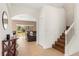 Bright foyer featuring tile floors, staircase, and open archways to living areas at 4822 Lake Milly Dr, Orlando, FL 32839