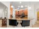 The kitchen features granite countertops, stainless steel appliances, and a breakfast bar with pendant lighting at 4822 Lake Milly Dr, Orlando, FL 32839