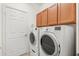 Laundry room with a washer, dryer, cabinets for storage and a door to outside at 4822 Lake Milly Dr, Orlando, FL 32839