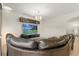 Spacious living room with large leather couch, media center, and modern lighting at 4822 Lake Milly Dr, Orlando, FL 32839