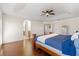 Spacious main bedroom with tray ceiling, wood floors, ceiling fan and ensuite bath at 4822 Lake Milly Dr, Orlando, FL 32839