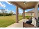 Spacious covered patio overlooking a large yard, perfect for outdoor entertaining and relaxation at 4822 Lake Milly Dr, Orlando, FL 32839