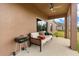 Relaxing covered patio featuring comfortable sofa seating and a grill for outdoor cooking at 4822 Lake Milly Dr, Orlando, FL 32839