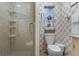 Bathroom with a walk-in shower, toilet, and small window at 4991 Tangerine Ave, Winter Park, FL 32792