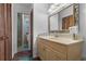 Bright bathroom with a vanity, mirror, glass enclosed shower, and linen closet at 4991 Tangerine Ave, Winter Park, FL 32792