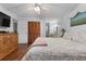 Comfortable bedroom with hardwood floors, closet, and an ensuite bathroom at 4991 Tangerine Ave, Winter Park, FL 32792