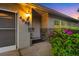 Inviting front entrance with a well-lit porch, decorative stone accents, a flower bush, and the house number displayed at 4991 Tangerine Ave, Winter Park, FL 32792