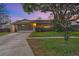Charming single-story home featuring a well-maintained lawn and an attached two-car garage with a screen door at 4991 Tangerine Ave, Winter Park, FL 32792