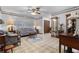 Comfortable living room with a ceiling fan, tile flooring, classic furnishings, and a decorative glass display cabinet at 4991 Tangerine Ave, Winter Park, FL 32792