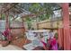 Outdoor dining area featuring a custom pergola and patio surrounded by colorful landscaping at 4991 Tangerine Ave, Winter Park, FL 32792