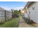 Well-maintained yard featuring a garden, grass, and a walkway along the side of the house at 4991 Tangerine Ave, Winter Park, FL 32792