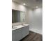 Bright bathroom featuring double sinks, modern fixtures, and a walk-in shower at 509 Coronado Cove Rd, New Smyrna Beach, FL 32168