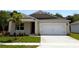 Charming single-story home featuring a well-maintained lawn and a two-car garage at 509 Coronado Cove Rd, New Smyrna Beach, FL 32168