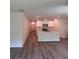 Open-concept layout with kitchen island, modern appliances, and wood flooring at 509 Coronado Cove Rd, New Smyrna Beach, FL 32168